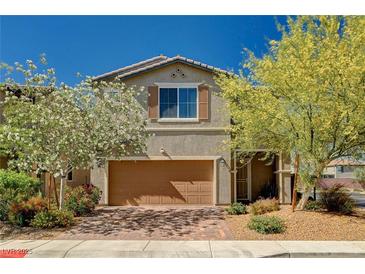Charming two-story home featuring a well-maintained front yard and a two-car garage at 8164 Golden Cholla Ave, Las Vegas, NV 89179