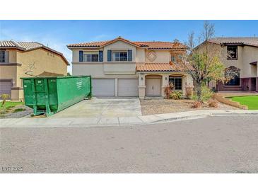 Charming two-story home with a tile roof and a two-car garage, awaiting landscaping and cleanup at 10135 Diving Duck Ave, Las Vegas, NV 89117