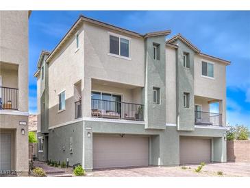 Townhome with a neutral color scheme, small balcony, and attached garage and desert landscaping at 6821 Prairie Pearl St, Las Vegas, NV 89148