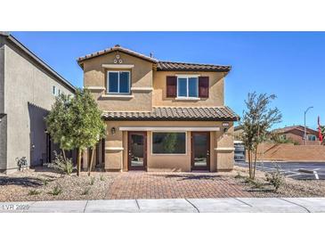 Charming two-story home boasts a well-manicured front yard and inviting curb appeal at 799 Calm Crystal Ct # Lot 142, North Las Vegas, NV 89081
