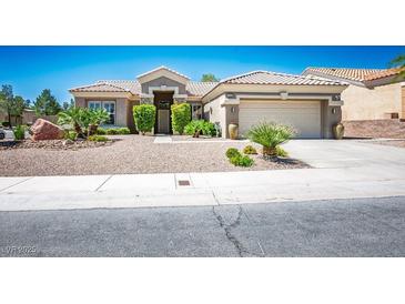 Charming single-story home with tile roof, desert landscaping, and attached two-car garage at 10301 Bent Brook Pl, Las Vegas, NV 89134