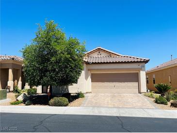 Charming single-story home featuring a well-manicured lawn, desert landscaping, and a two-car garage at 248 Windmill Croft Dr, Las Vegas, NV 89148