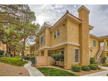 Charming two-story condo featuring a stucco exterior, red tile roof, and well-maintained landscaping at 251 S Green Valley Pkwy # 1311, Henderson, NV 89012
