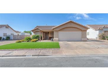 Charming single story home featuring a two-car garage and manicured front yard at 452 Waterwheel Falls Dr, Henderson, NV 89015