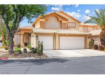 Charming two-story home featuring a two-car garage and desert landscaping in the front yard at 5449 Desert Spring Rd, Las Vegas, NV 89149
