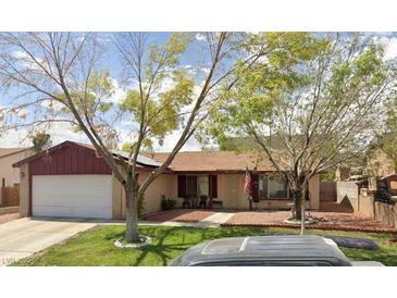 Charming single-story home featuring a well-manicured front lawn and a traditional two-car garage at 5921 San Fernando Dr, Las Vegas, NV 89108