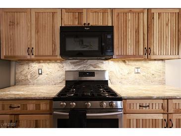 Up-close kitchen view highlighting the modern appliances and light wooden cabinetry with matching countertops at 6016 Bungalow Bay St, Las Vegas, NV 89130