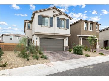Charming two-story home with a two-car garage and beautiful landscaping at 6611 Dove Point Pl, Las Vegas, NV 89130