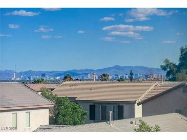 Scenic view of the Las Vegas city skyline with mountains and clear blue sky, taken from a residential neighborhood at 6844 Tropicaire St, Las Vegas, NV 89149