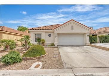 Charming single-story home with a two-car garage and desert landscaping at 7929 Ben Hogan Dr, Las Vegas, NV 89149