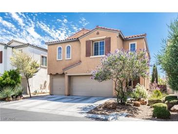 Two-story home featuring a neutral exterior, attached garage, and well-maintained landscaping at 9856 Chief Sky St, Las Vegas, NV 89178