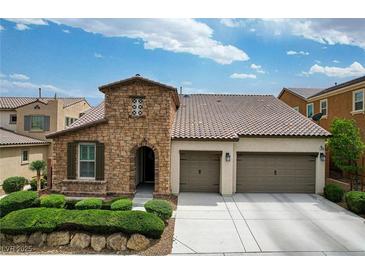 Charming single-Gathering home with a stone facade, two-car garage, and well-maintained landscaping at 1005 Old Creek Way, North Las Vegas, NV 89084