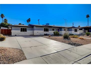 Charming single-story home with a spacious driveway and desert landscaping at 1631 Ottawa Dr, Las Vegas, NV 89169