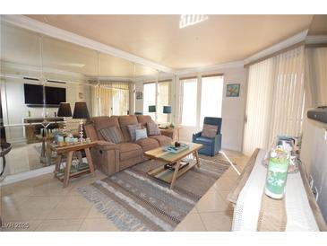 Inviting living room featuring tile floors, a comfortable couch, and plenty of natural light at 270 E Flamingo Rd # 223, Las Vegas, NV 89169