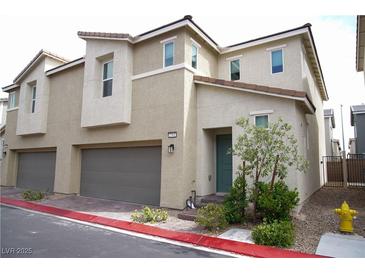 Charming two-story home featuring neutral stucco, red tile roof, and an attached two-car garage at 2761 Frosted Teal Ave, North Las Vegas, NV 89086