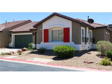 Charming single-story home with red shutters, well-maintained landscaping, and a two-car garage at 2840 China Cove St, Laughlin, NV 89029
