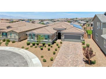 Beautiful single story home featuring desert landscaping, brick paver driveway, and a two car garage at 2910 Monate Ct, Henderson, NV 89044