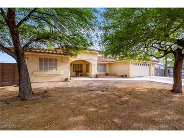 Charming single-story home with desert landscaping and covered porch at 3481 Winery Rd, Pahrump, NV 89048