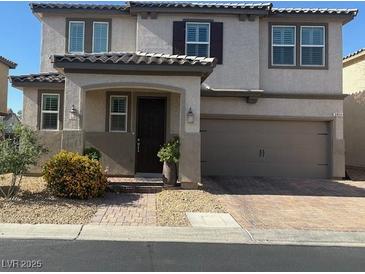 Charming two-story home featuring a two-car garage, neutral stucco, and a tile roof, complemented by front yard landscaping at 3854 Stadium Ave, Las Vegas, NV 89120