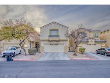 Inviting two-story home featuring a well-kept front yard, neutral tones, and an attached two-car garage at 6525 Raven Hall St, North Las Vegas, NV 89084
