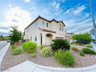Charming two-story home with neutral stucco, tiled roof, landscaped front yard, and a two-car garage at 7083 Seat Wall Rd, Las Vegas, NV 89148
