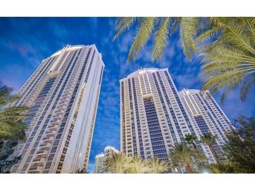 Striking exterior shot of a modern high-rise building with palm trees and blue skies at 135 Harmon Ave # 3220, Las Vegas, NV 89109