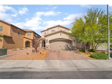 Inviting two-story home featuring a neutral color scheme, two-car garage, and charming desert landscaping at 162 Sand Lake St, Henderson, NV 89074