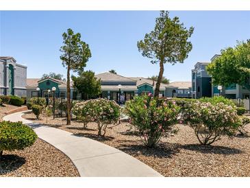 Inviting clubhouse exterior with manicured landscaping and a welcoming walkway at 6955 N Durango Dr # 2081, Las Vegas, NV 89149