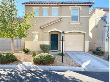 Two-story home with desert landscaping, covered entry, attached garage and concrete driveway at 7249 Old Glory St, Las Vegas, NV 89148
