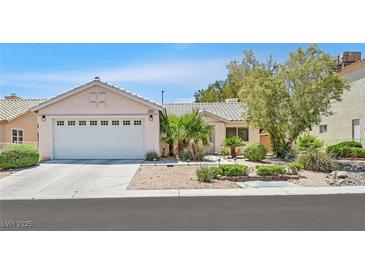 Charming single-story home with a well-maintained lawn and a two car garage at 7645 Falconwing Ave, Las Vegas, NV 89131