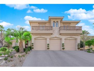 Impressive three-car garage home featuring beautiful balconies, stone accents, and manicured landscaping at 807 Canyon Greens Dr, Las Vegas, NV 89144