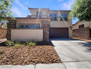 Inviting two-story home with a well-manicured front yard and an attached two-car garage at 9319 Bronze River Ave, Las Vegas, NV 89149