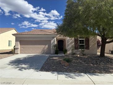 Charming single-story home featuring a two-car garage and inviting front yard landscaping at 2224 Waterton Rivers Dr, Henderson, NV 89044