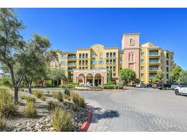 Beautiful condo complex with arched entry, water feature, mature landscaping, and ample parking at 30 Strada Di Villaggio # 306, Henderson, NV 89011