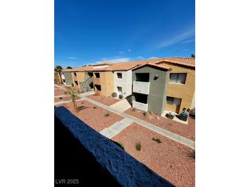 Inviting exterior view of condo with colorful landscaping, walkways, and ample parking at 3151 Soaring Gulls Dr # 2101, Las Vegas, NV 89128