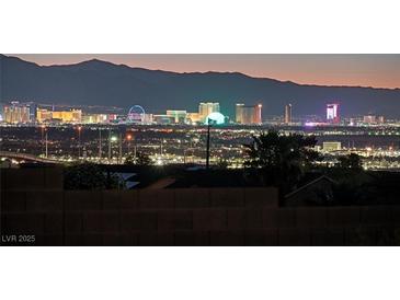 Stunning Las Vegas skyline view at night with mountains in the background, showcasing city lights at 392 Waterwheel Falls Dr, Henderson, NV 89015