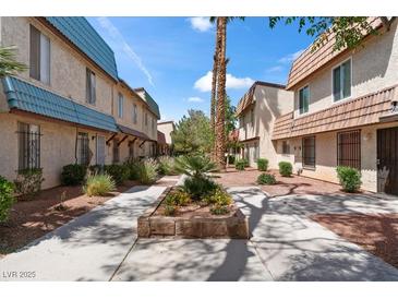 Townhouse exteriors feature desert landscaping and concrete walkways for easy access to each unit at 4000 Visby Ln, Las Vegas, NV 89119