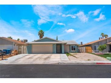 Inviting single-story home featuring a spacious driveway and a well-maintained front yard landscape at 508 Purcell Dr, Las Vegas, NV 89107