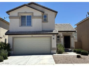 Two-story home featuring a two-car garage, neutral stucco, and a well-maintained yard at 7282 Quarterhorse Ln, Las Vegas, NV 89148