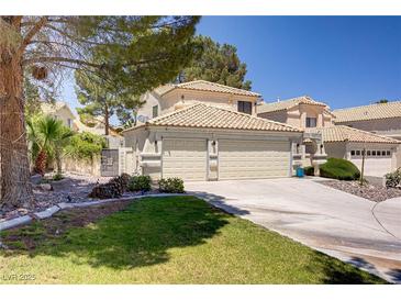 Inviting front exterior with a well-maintained lawn and a spacious two-car garage at 9552 Wooden Pier Way, Las Vegas, NV 89117