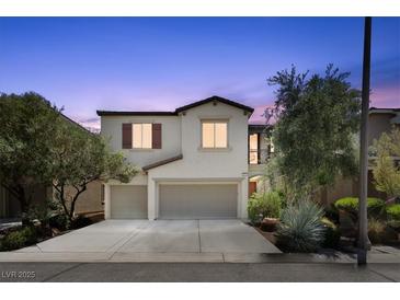 Two-story home featuring a spacious two car garage, neutral paint, and tasteful landscaping at 9872 Chief Sky St, Las Vegas, NV 89178