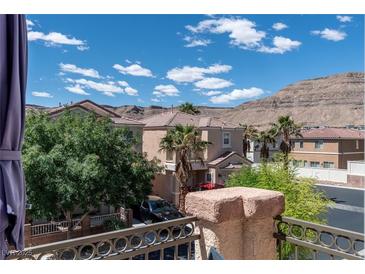 View of the home's exterior, showcasing the desert landscaping and mountain views at 9962 Derby Creek Way, Las Vegas, NV 89148