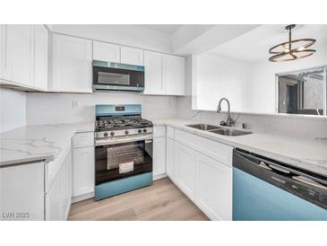 Bright kitchen features new appliances, marble countertops, and white cabinets at 1424 Santa Anita Dr # D, Las Vegas, NV 89119
