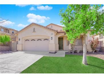 Inviting single-story home featuring a well-manicured lawn and two-car garage under a bright blue sky at 177 Rocky Star St, Henderson, NV 89012
