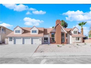 Inviting home featuring a three-car garage, red brick accents, and a pristine, low-maintenance landscaped yard at 2160 Pueblo Cir, Las Vegas, NV 89169