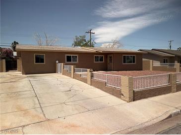 Charming single-story home with a well-maintained yard and white picket fence at 3219 Bluebird St, Las Vegas, NV 89121