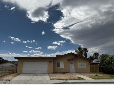 Single story home with a two car garage and low maintenance landscaping at 4189 Studio St, Las Vegas, NV 89115