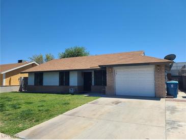 Charming single-story home with a well-maintained lawn and a spacious driveway leading to an attached garage at 4437 Sherrill Ave, Las Vegas, NV 89110