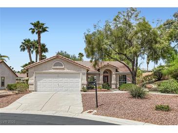 Charming single-story home featuring a well-maintained front yard with mature trees and a two-car garage at 5529 Cranwood Ct, Las Vegas, NV 89130
