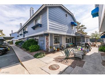 Charming two-story home with blue siding, inviting front patio, and well-maintained landscaping at 5831 Medallion Dr # 103, Las Vegas, NV 89122